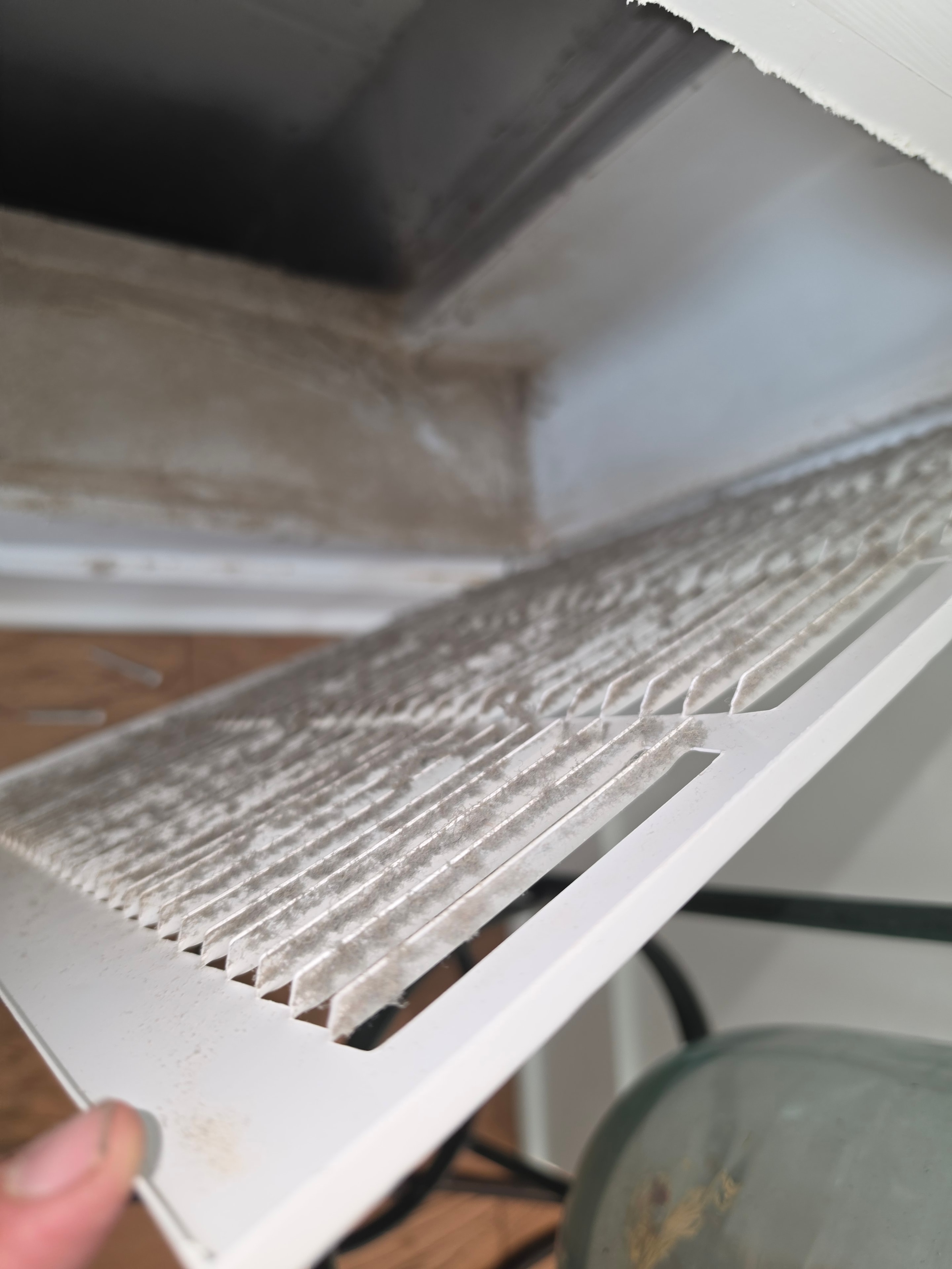 Vent cover packed with construction dust, skin cells, and pet dander — Princeton NJ home before cleaning