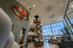 HVAC Cleaning Specialists cleaning air ducts in a high ceiling of a commercial building